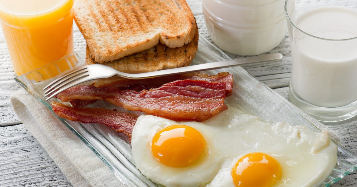 Bacon eggs orange juice breakfast foods